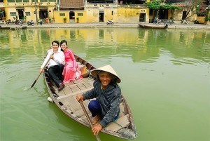 Couple sightseeing on boat along Hoai river